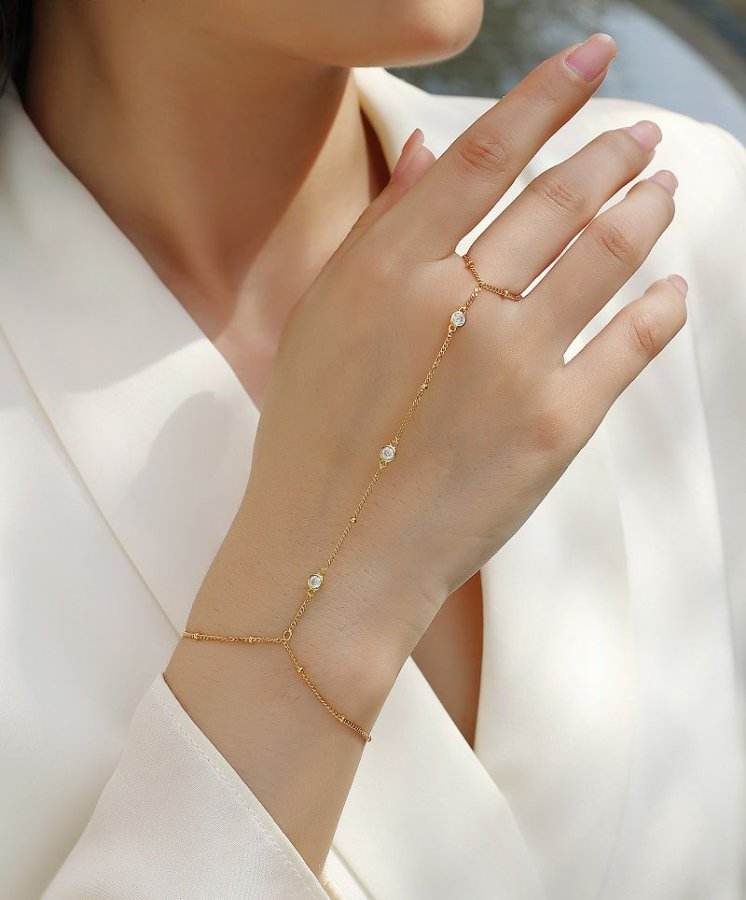 Bracelet worn for elegant evening or holiday party. Alt: “Holiday Sparkle: 18K Gold Moissanite Bracelet.”