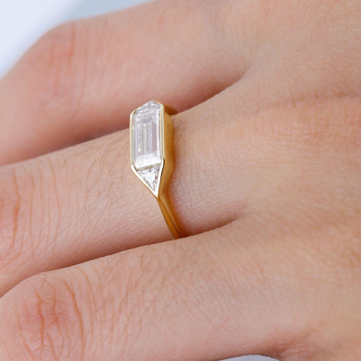 Clean, modern flat lay featuring 4–5 geometric rings on architectural backdrop. Alt: “1.4CT Geometry Moissanite Engagement Rings – Modern Collection.”