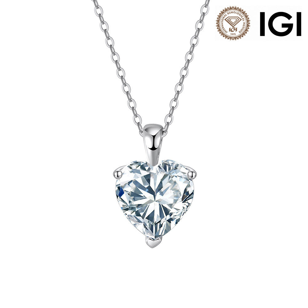 A heart-shaped clear gemstone pendant necklace in a silver setting on a delicate silver chain, shown against a plain white background with an IGI certification logo in the top right corner.