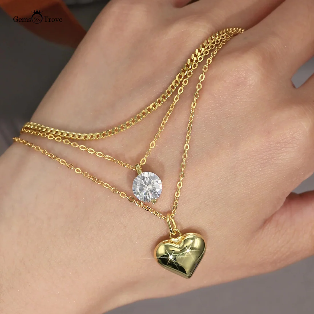 Macro, necklace draped across female hand, natural curve, warm soft light, mirror metal shine, sharp sparkle, blurred skin background, detailed texture, intimate luxury feel.