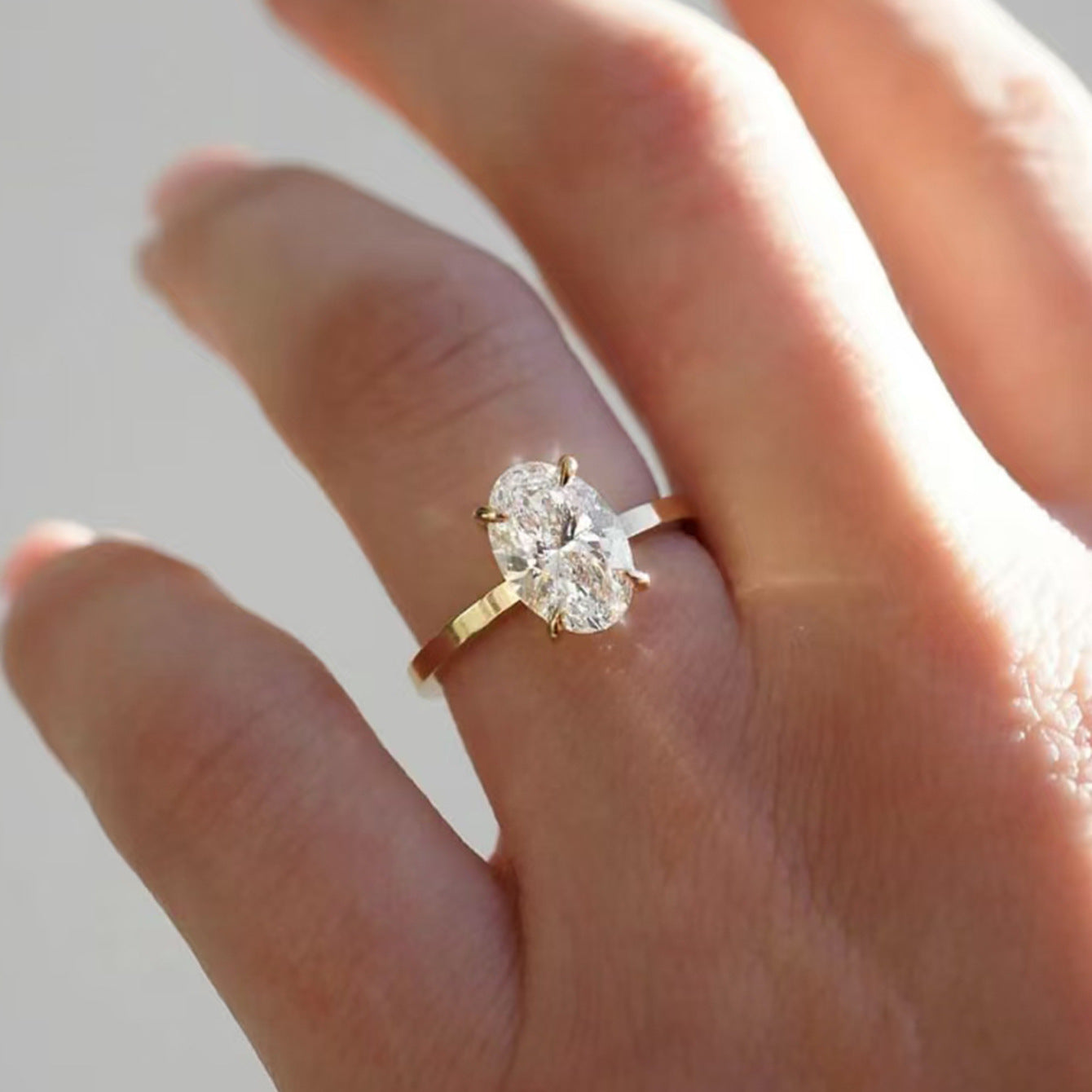 Ring worn as elegant engagement ring. Alt: “Timeless Elegance: 2.5CT Oval Moissanite Ring.”
