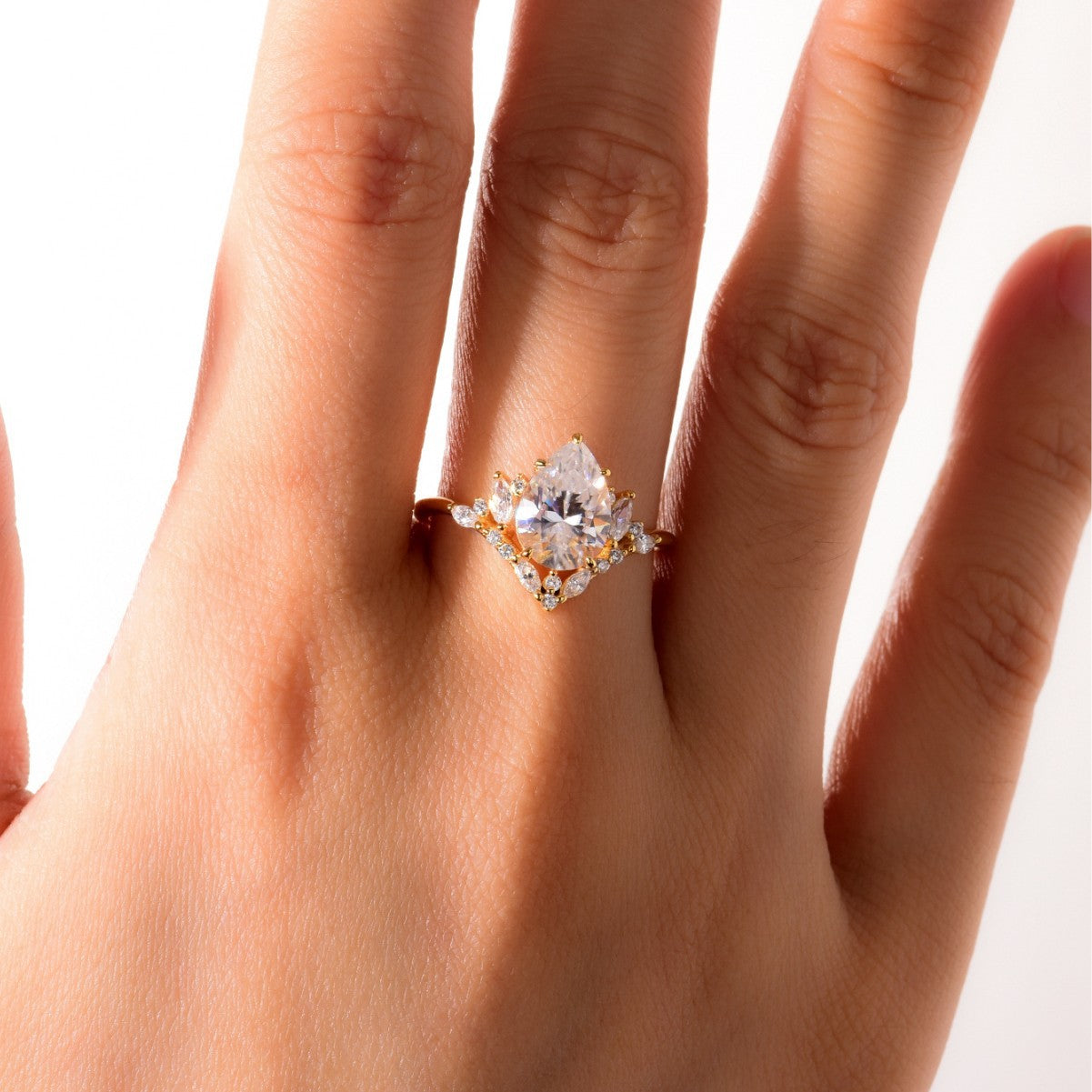 Ring worn as elegant engagement ring. Alt: “Fluid Elegance: 2CT Water Drop Moissanite Ring.”