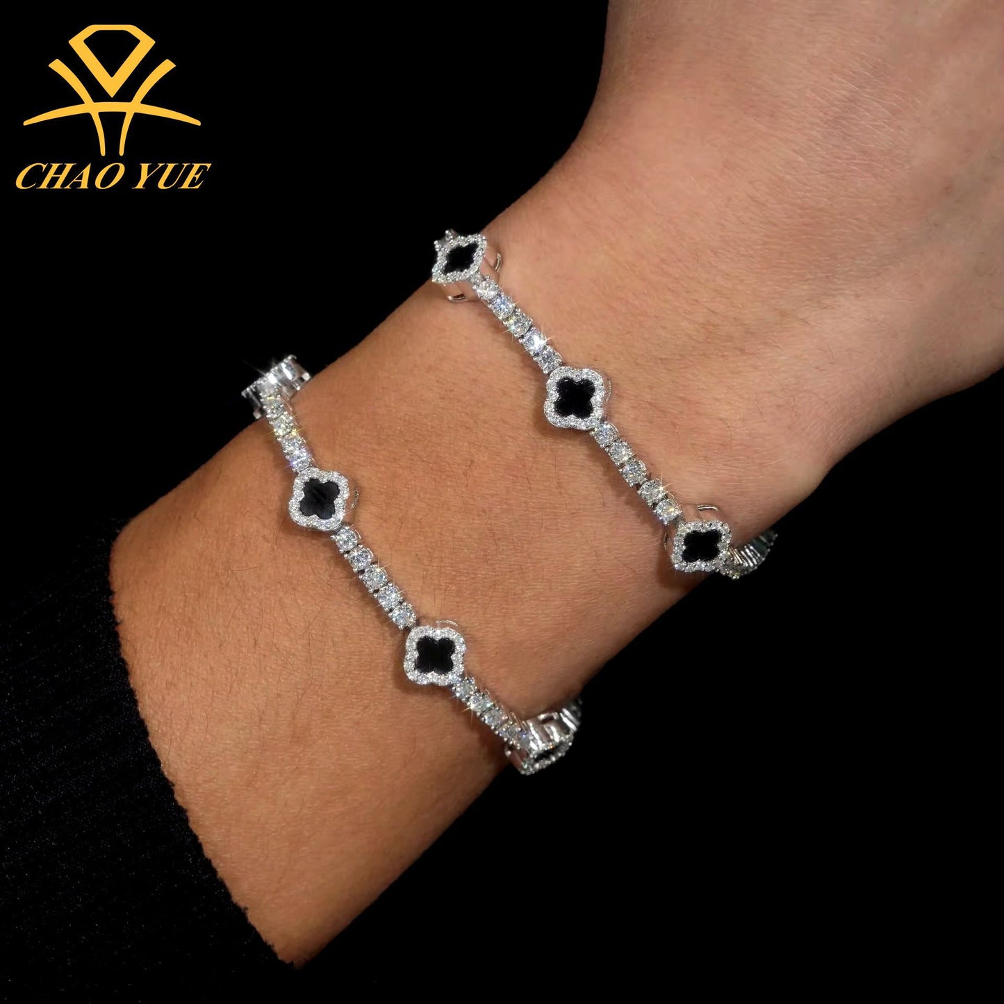 Silver bracelet with black stones on a wrist, brand 'Chao Yue' visible