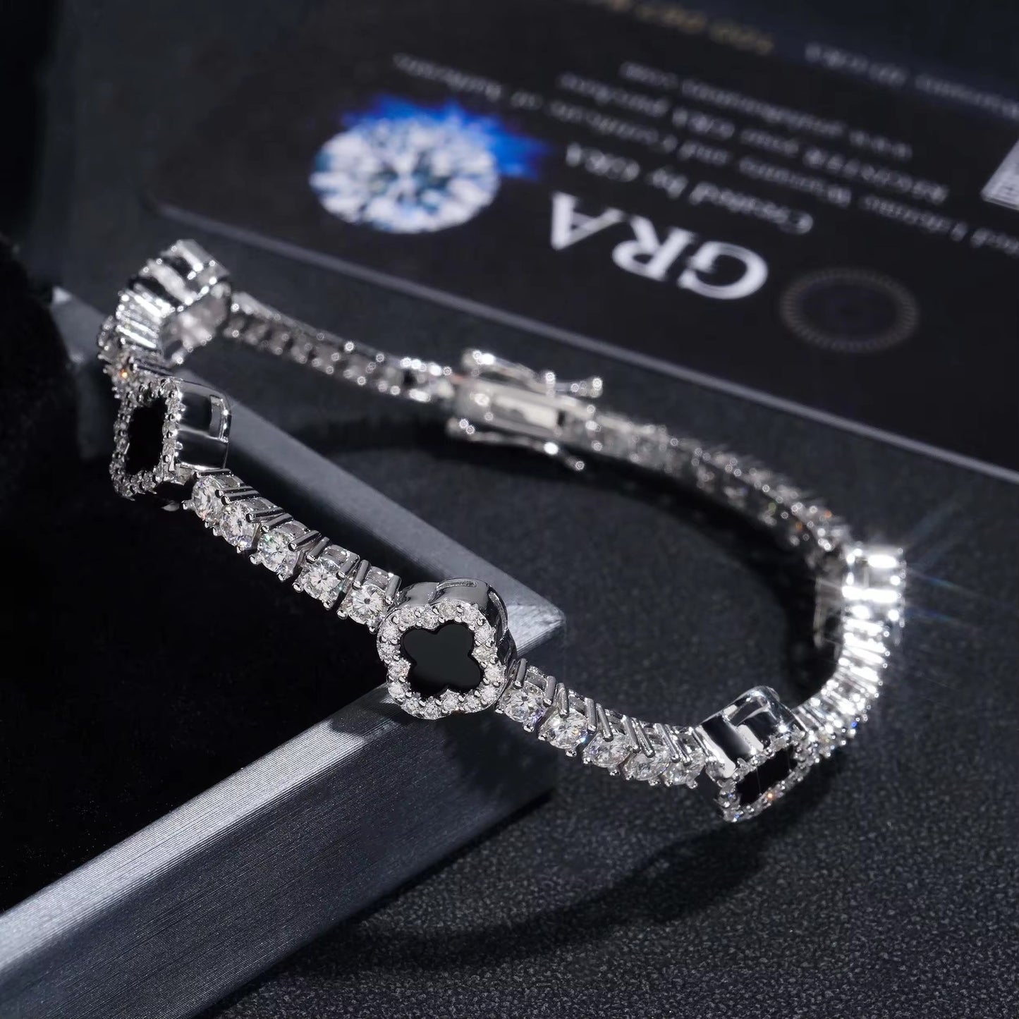 Silver bracelet with clear stones on a black background