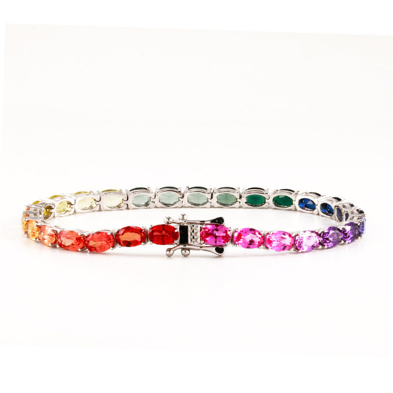 Silver 4x6mm oval cut rainbow gradient moissanite tennis bracelet with box clasp on white background