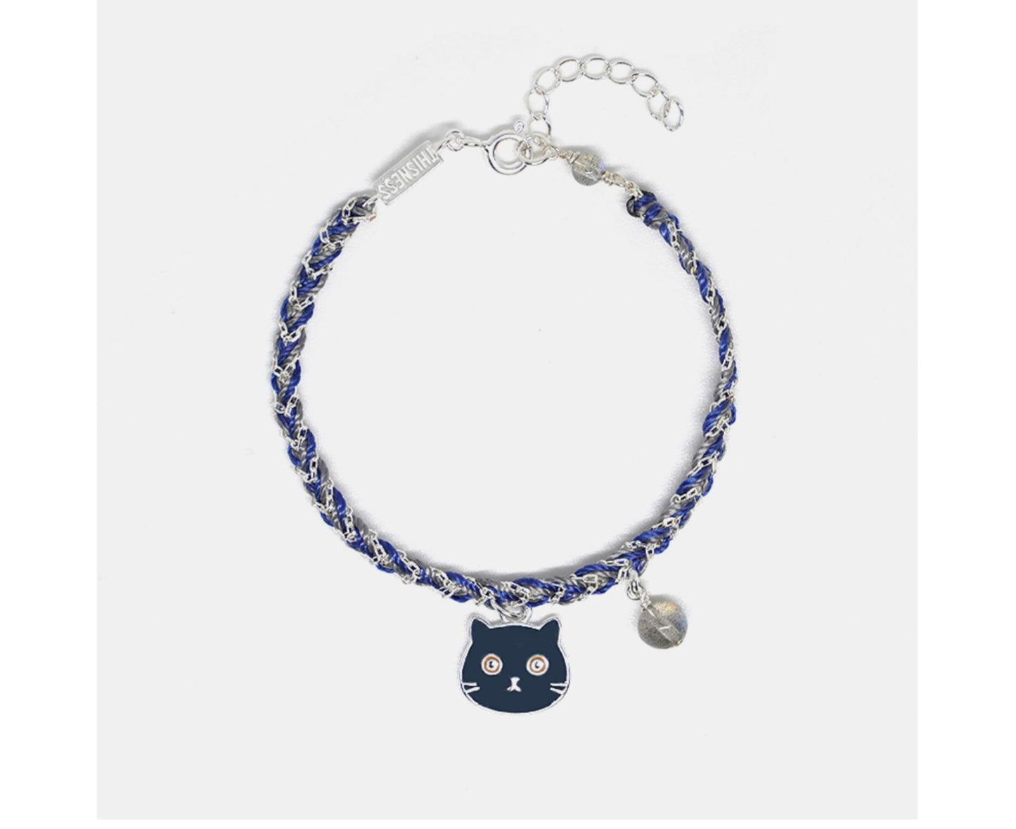 Bracelet with a cat charm and blue beads on a white background