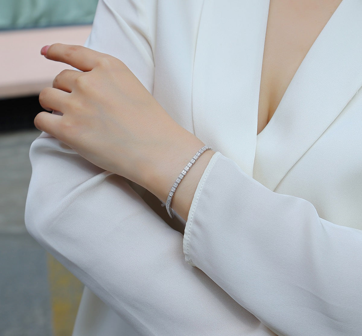 Bracelet stacked with other pieces. Alt: “Stackable Elegance: Moissanite Tennis Bracelet.”