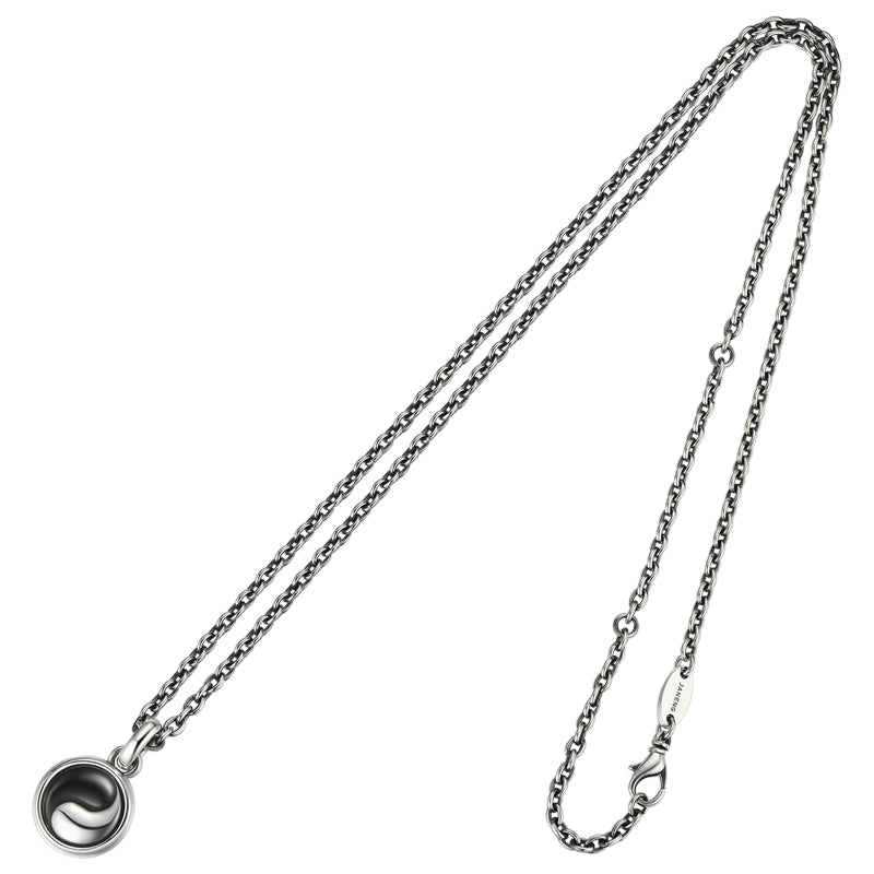 Silver chain necklace with a small pendant on a white background