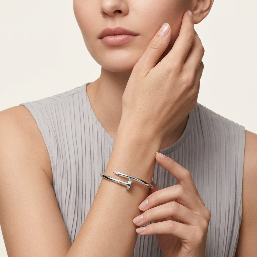 Woman wearing a silver bracelet on a neutral background