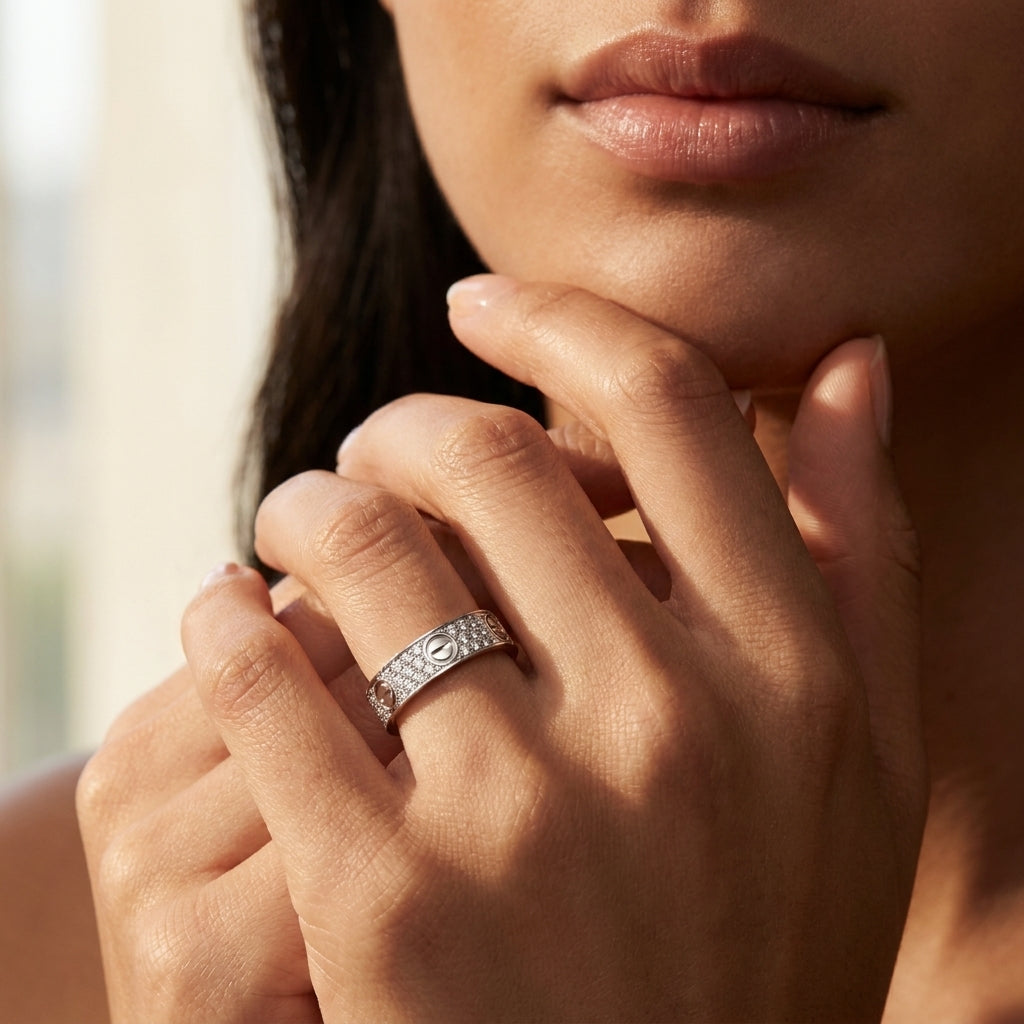 Close-up of a woman's hand wearing a diamond ring with a blurred background