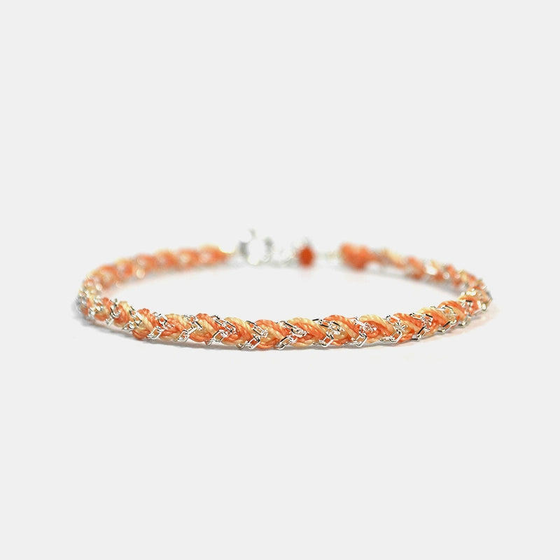 Bracelet with orange beads on a white background