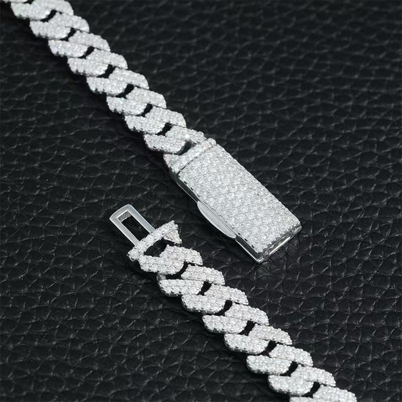 Silver braided chain bracelet on a black textured background