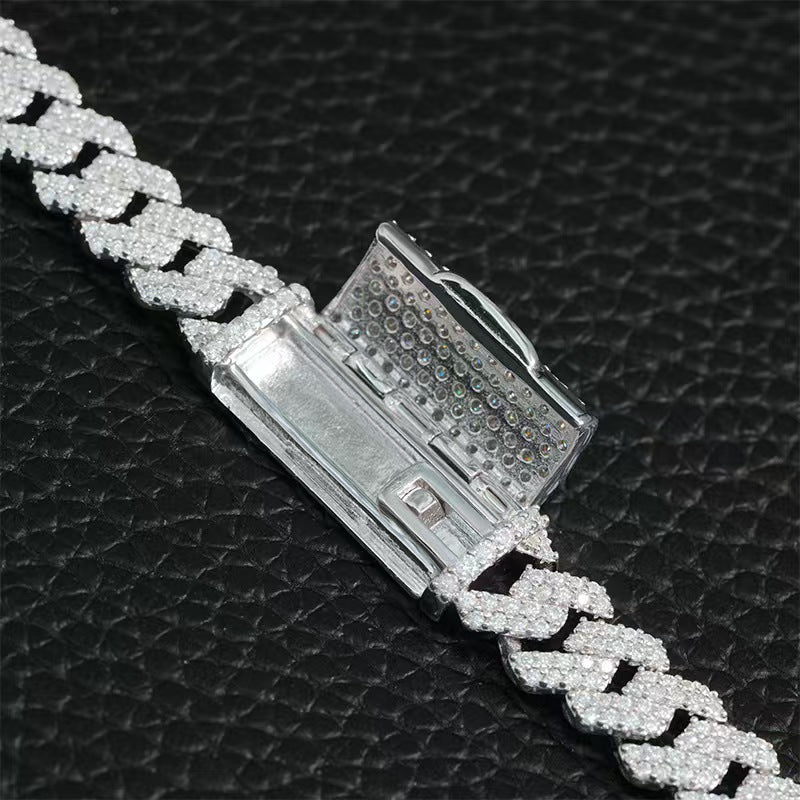 Silver chain bracelet with diamond-like crystals on a black textured background