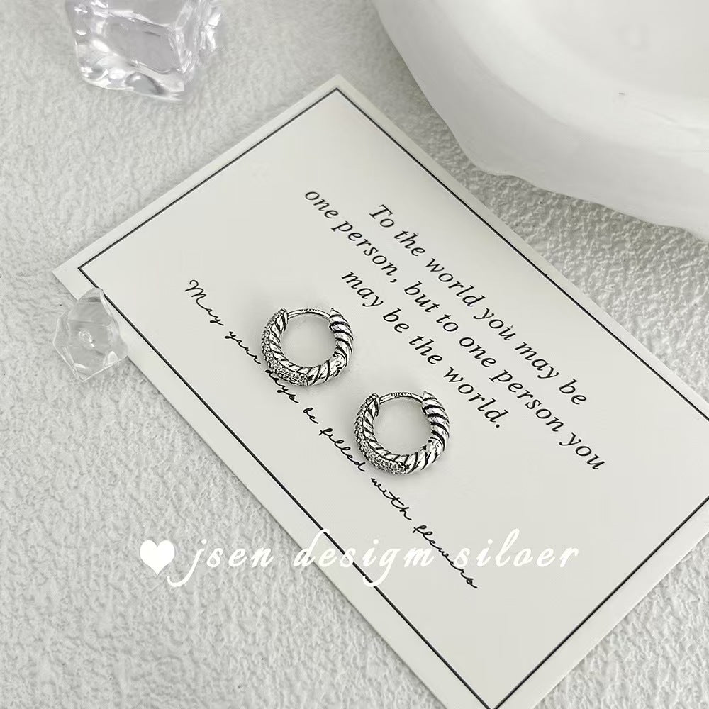 Silver hoop earrings on a card with text and 'joen design silver' branding.