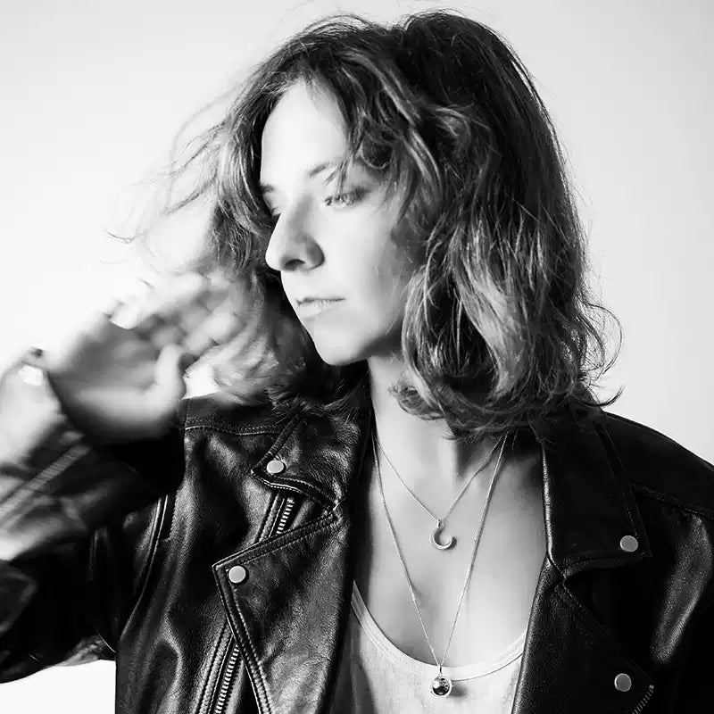 Black and white photo of a person wearing a leather jacket.