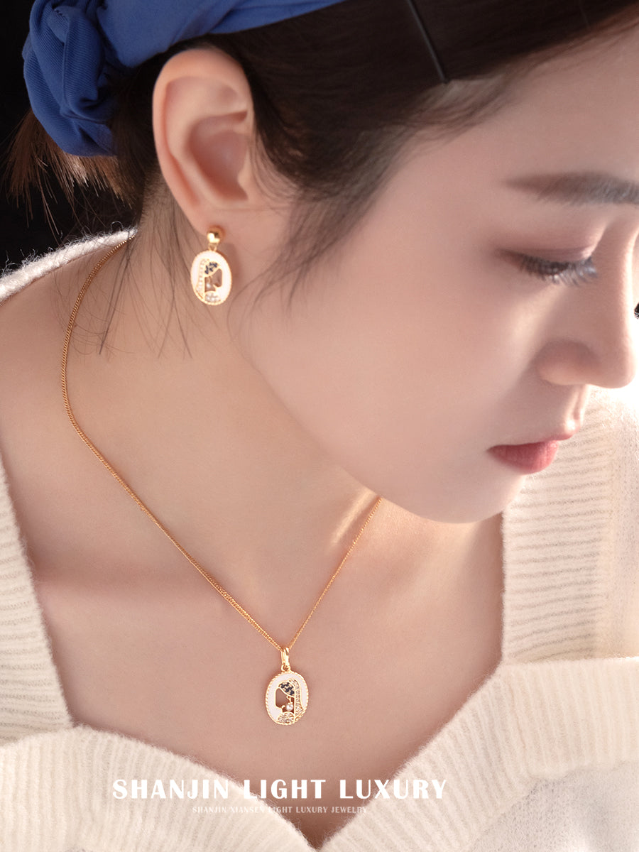Close-up of a person wearing gold earrings and necklace with 'Shanjin Light Luxury' branding.