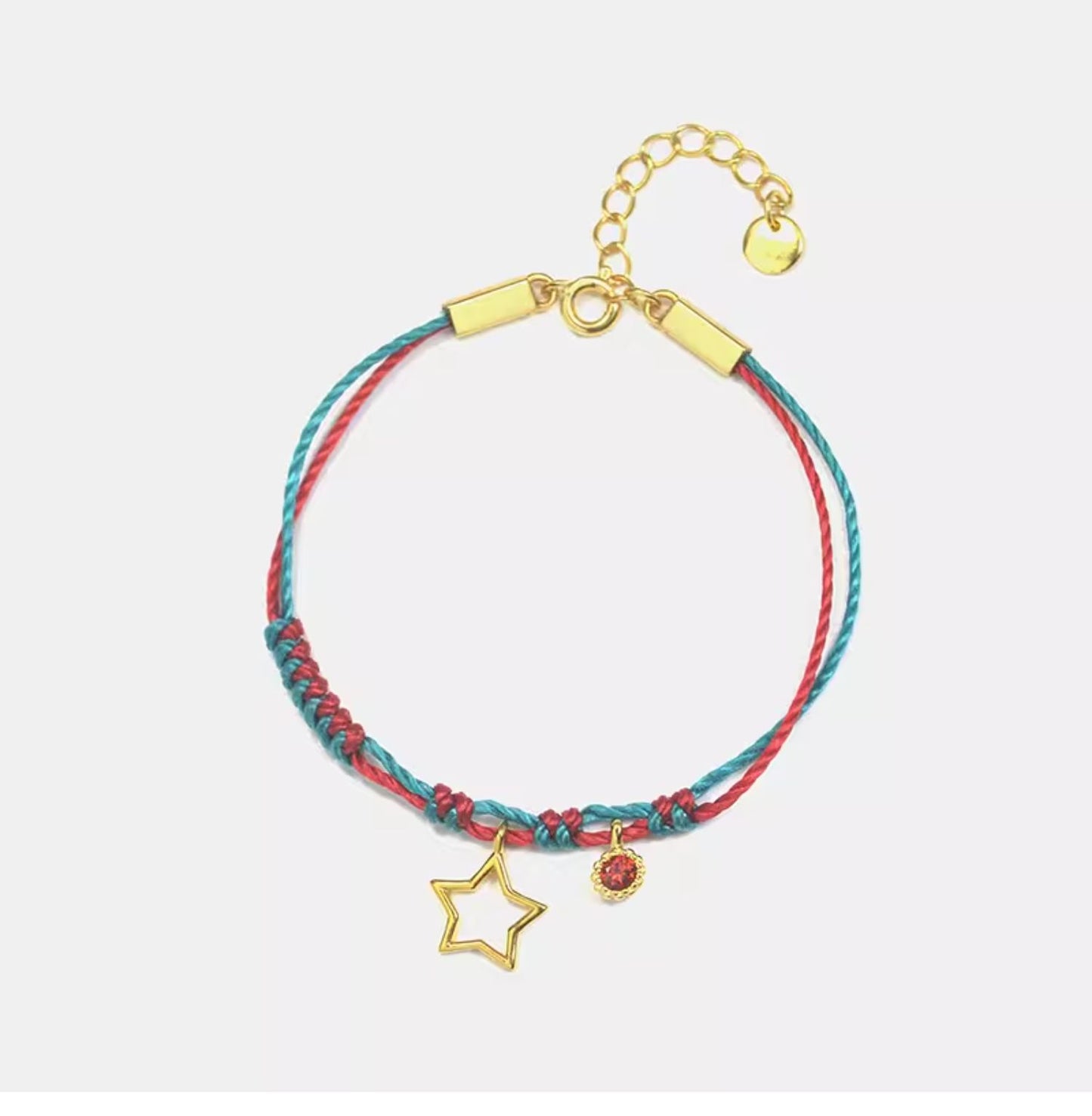 This Gold-Plated Sterling Silver Star Bracelet combines vibrant red and green braided cords with a finely crafted five-pointed star charm.