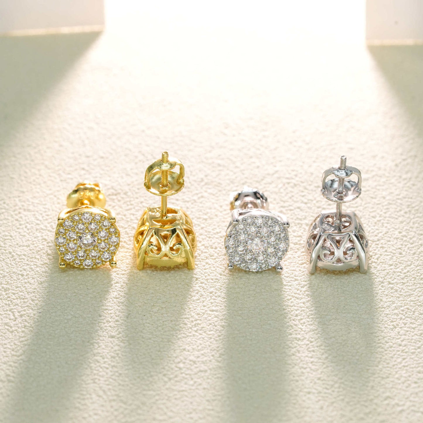 Pair of gold and silver earrings on a light background