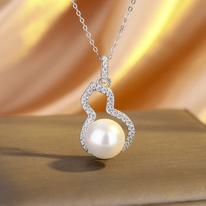 Pearl necklace with a heart-shaped pendant on a beige background
