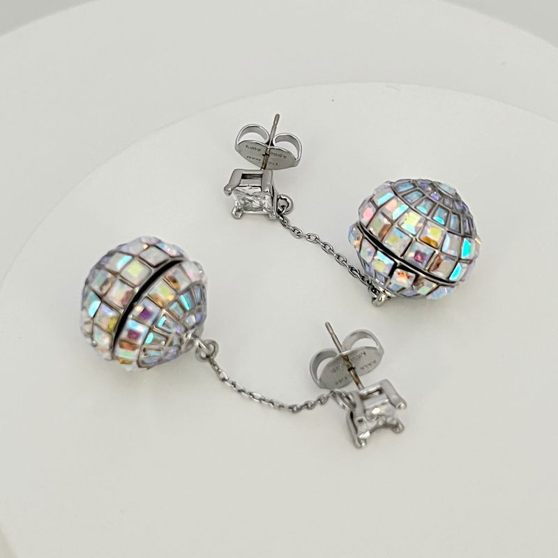 Earrings on a soft black or silver glitter background, showcasing the linear cascade of mirror tiles catching light. Alt: “Kate Spade Beaming Bright Disco Ball Linear Earrings – Mirror Tile Drop Jewelry.”