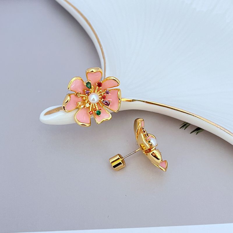Earrings on soft pink or garden-green background. Alt: “Kate Spade Bloom In Color Statement Stud Earrings – Multicolor Enamel Floral Jewelry.”