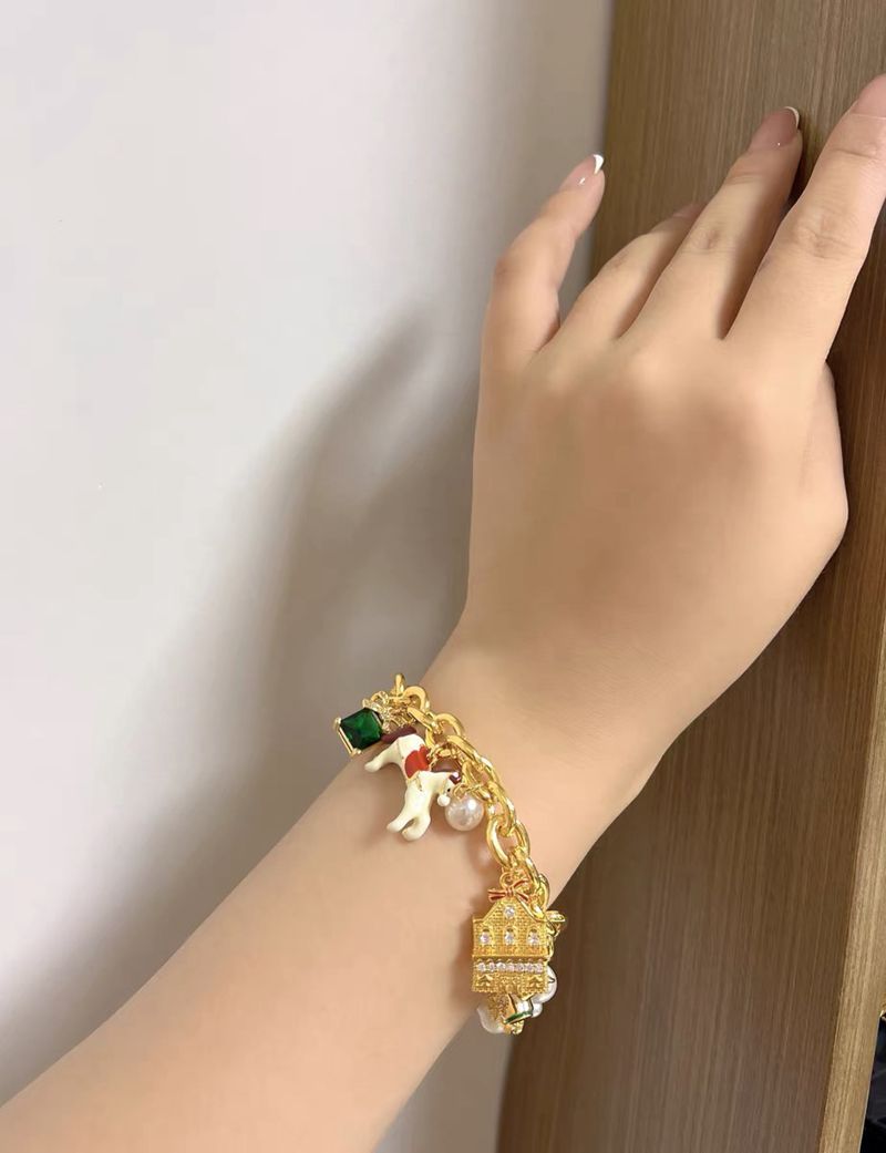 Bracelet styled alongside vintage carousel figurines, fairy lights, or a storybook for a nostalgic, magical aesthetic. Alt: “A Touch of Magic: Styling the Kate Spade Carousel & Owl Bracelet.”