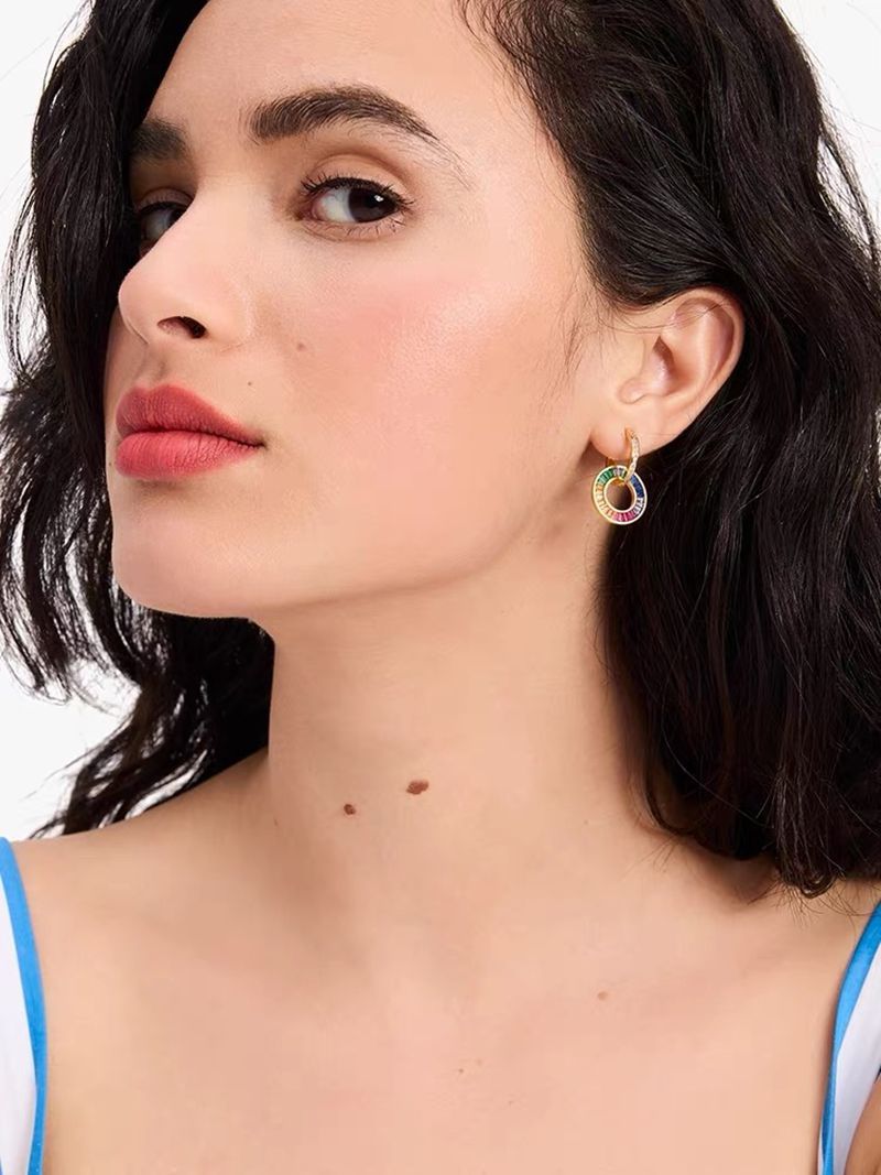 A smiling, confident woman wearing the necklace with a simple black or white dress, allowing the colors to be the star.