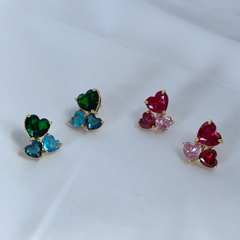 Earrings on a soft blush or cream background, showcasing the crystal-pavé heart shape. Alt: “Kate Spade Gold-Tone Heart Cubic Zirconia Earrings – Crystal Heart Stud Jewelry.”