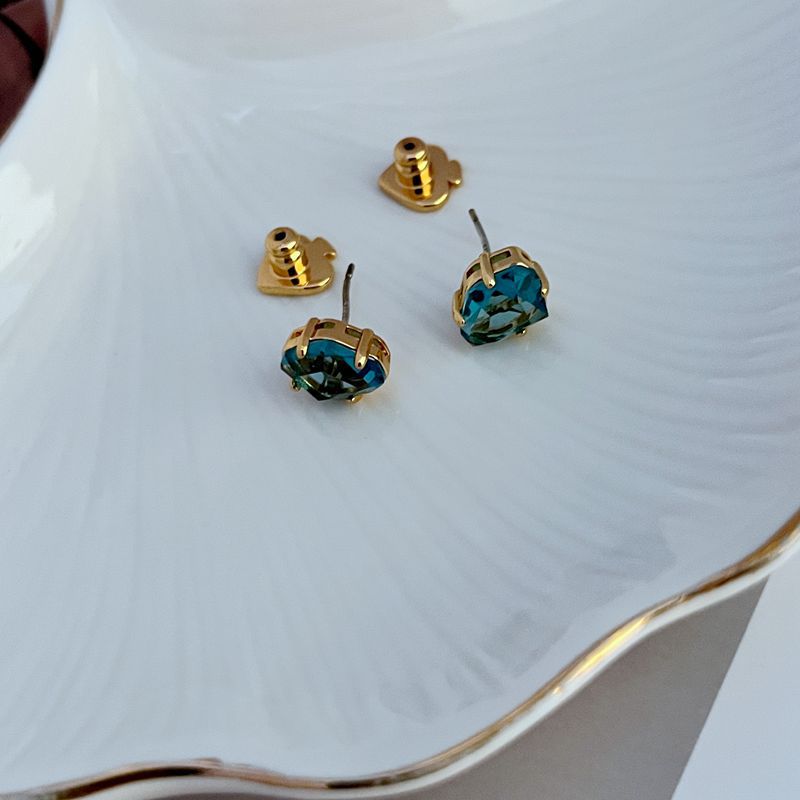 Macro focus on the enamel disc, showcasing the serene blue finish and elegant gold foil script. Alt: “Light Blue Enamel with Gold 'Rise and Shine' Detail – Kate Spade Earrings.”