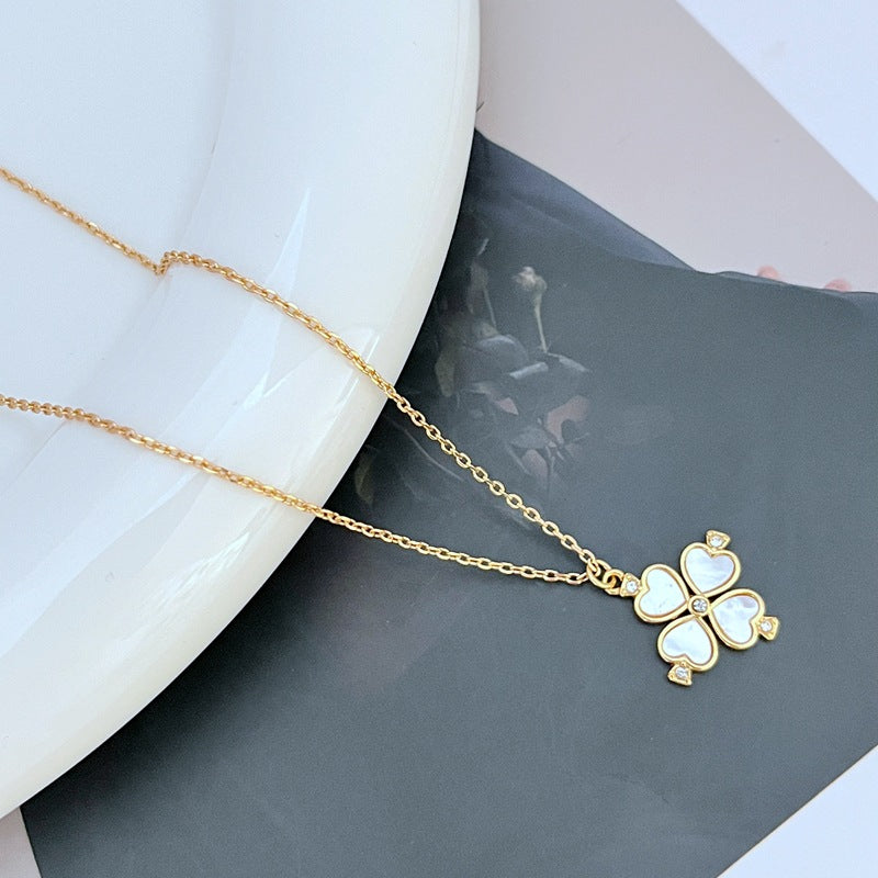 Mini spade pendant necklace on a soft pink or neutral backdrop, highlighting its delicate scale and engraved details. Alt: “Kate Spade Legacy Spade Flower Mini Pendant Necklace – Dainty Logo Jewelry.”