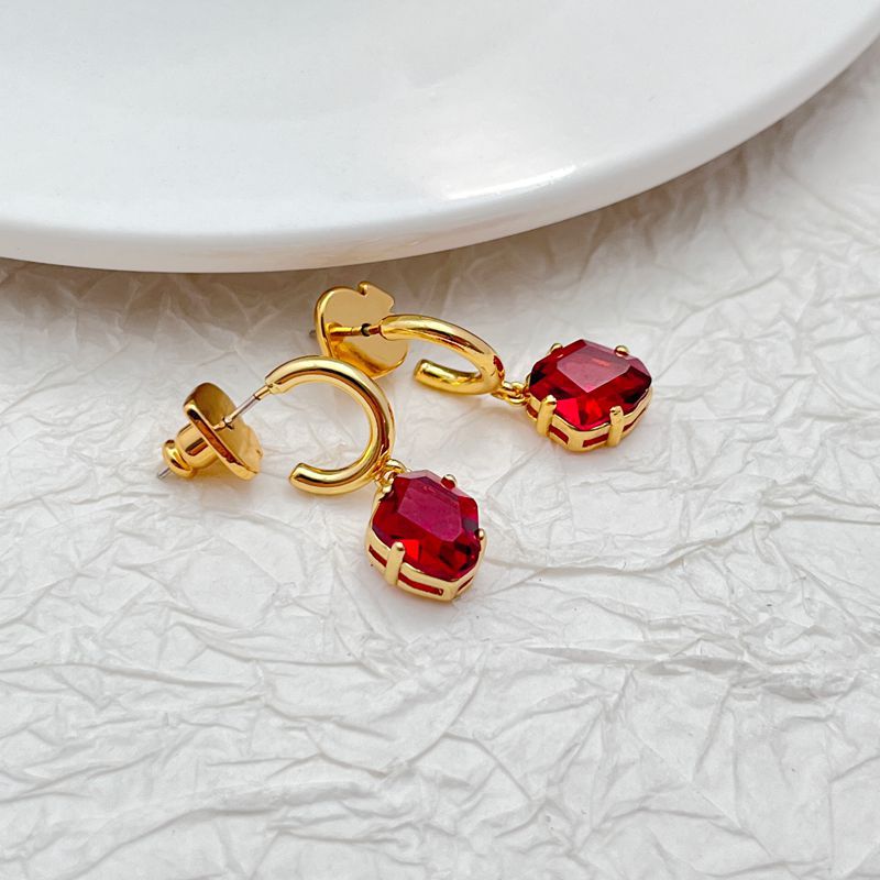 Earrings on a clean white or soft navy background, showcasing the huggie hoop and dangling charm. Alt: “Kate Spade Treasure Trove Drop Huggie Hoop Earrings – Gold Key Charm Earrings.”