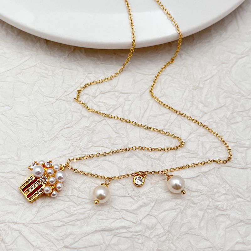 Clean, bright shot of the necklace on a solid, playful background, highlighting the detailed popcorn charm.