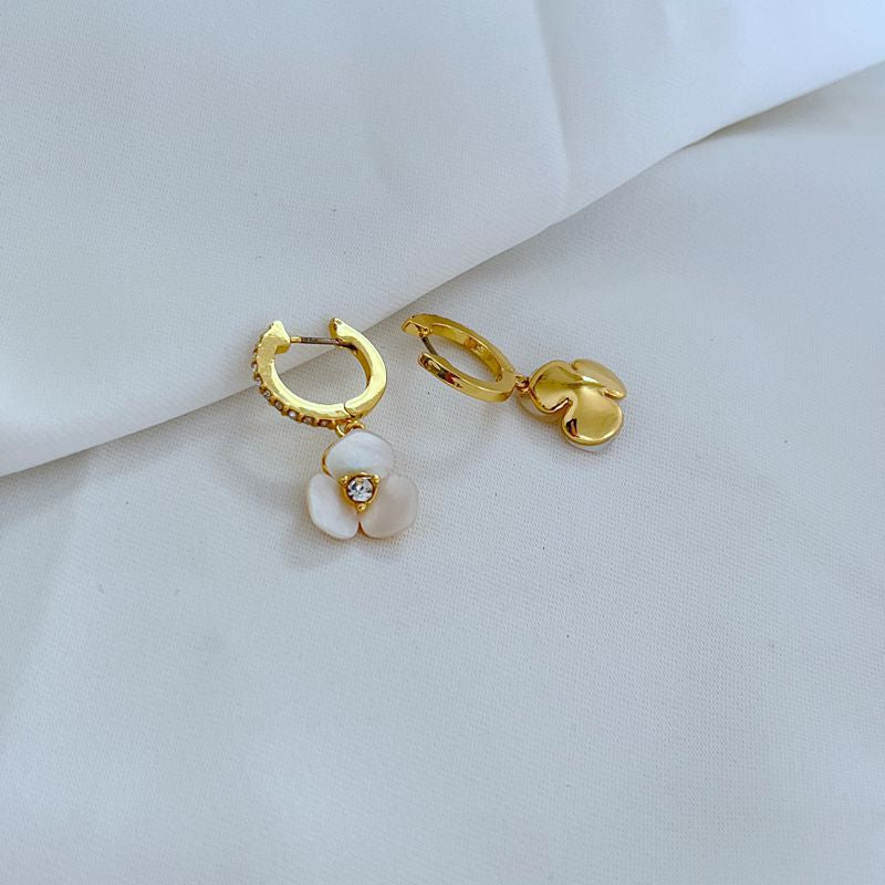 Extreme close-up on the pansy charm, showcasing the intricate petal texture and sculptural detail.