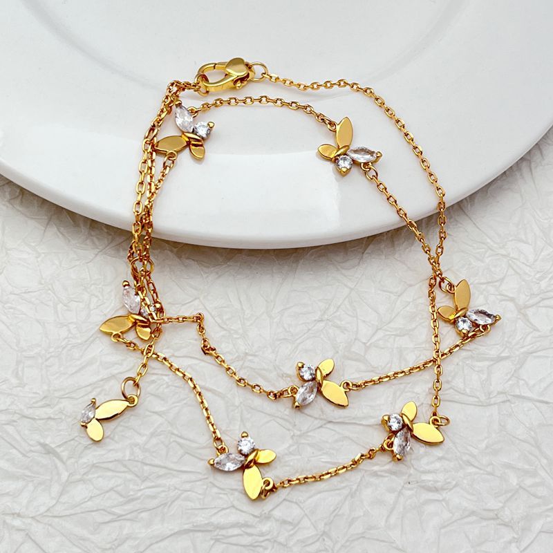 Necklace displayed on a clean, light background, showcasing the layered chains and sparkling butterfly pendant. Alt: “Kate Spade Social Butterfly Double Strand Necklace – Crystal Butterfly Layered Jewelry.”