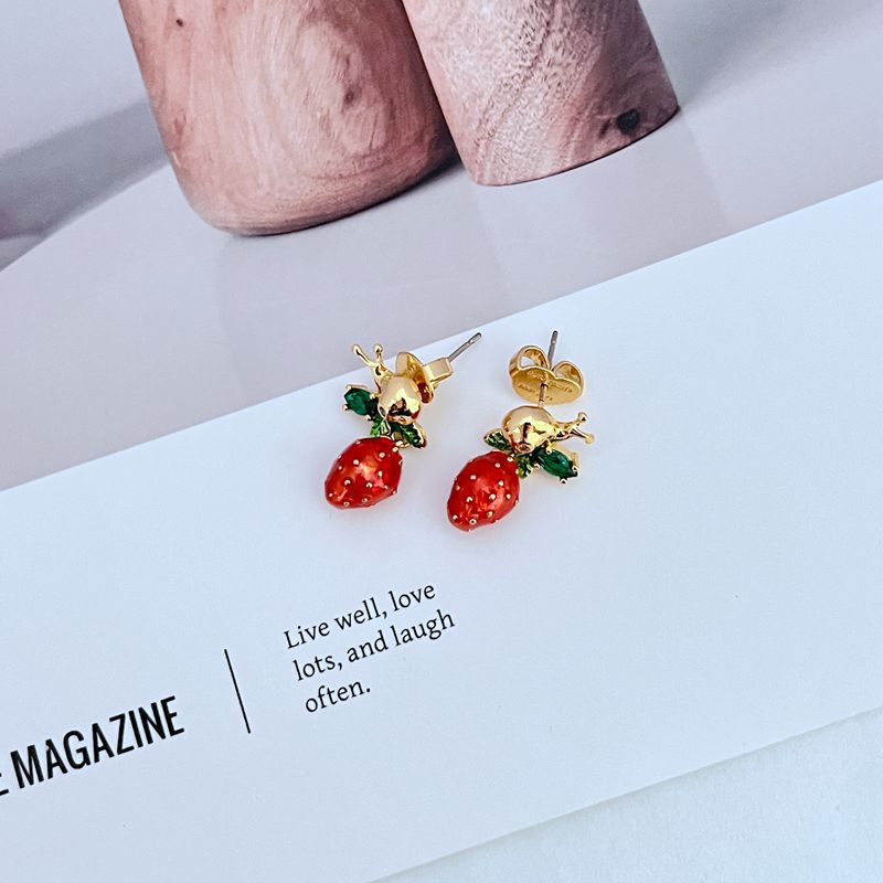 Earrings on soft pink or garden green background. Alt: “Kate Spade Strawberry Fleur Drop Earrings – Enamel Fruit Floral Jewelry.”