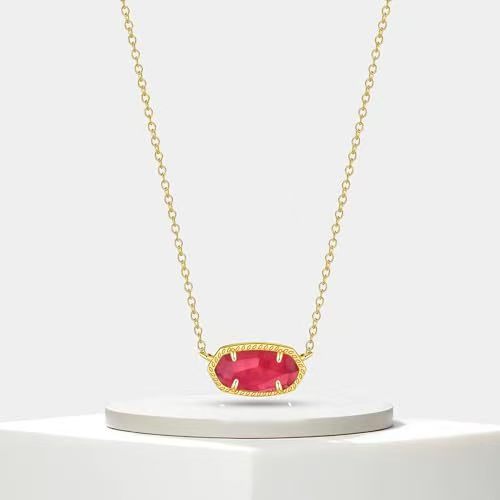 Gold necklace with a red gemstone on a white background