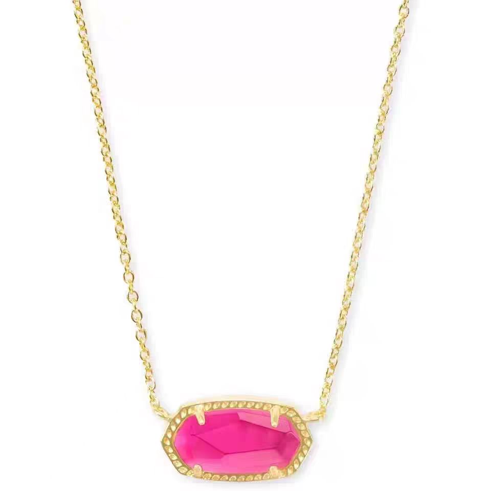 Necklace with a pink pendant on a gold chain against a white background