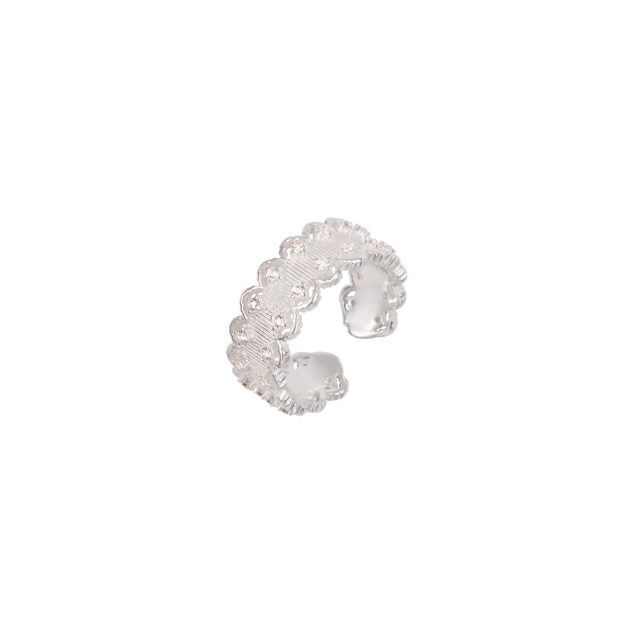 Silver ring with intricate design on a white background