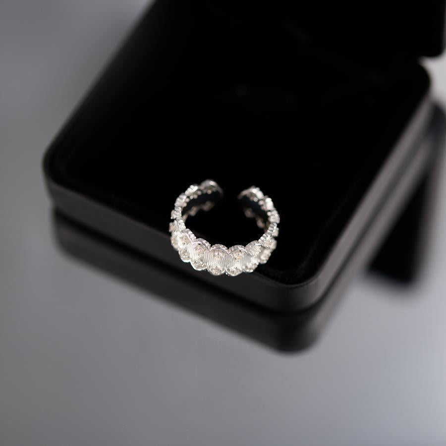 Silver ring with diamonds on a black jewelry box