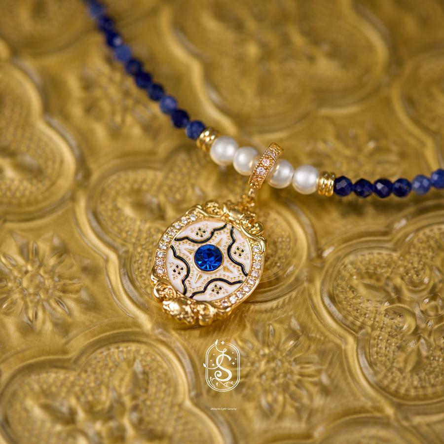 Necklace with blue and white beads on a gold textured background