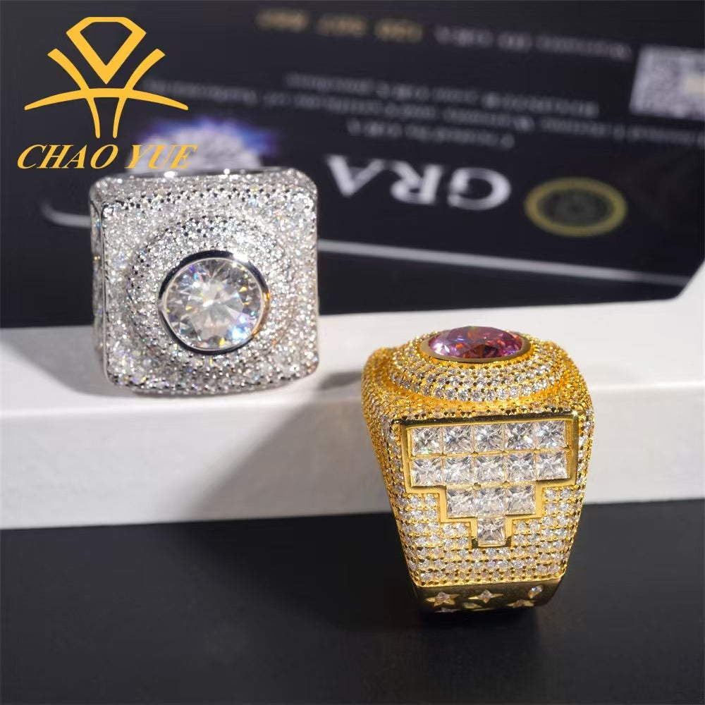 Two diamond-encrusted rings on a reflective surface with a blurred background.