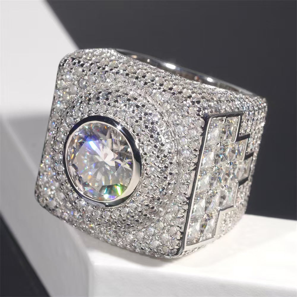 Luxury diamond-encrusted ring on a reflective surface with a dark background