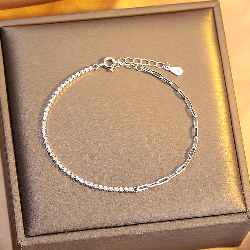 Silver bracelet with chain and beaded design on a brown box