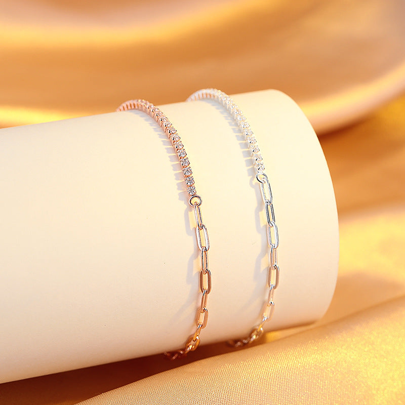 Two gold bracelets on a white cylindrical object with a gold background