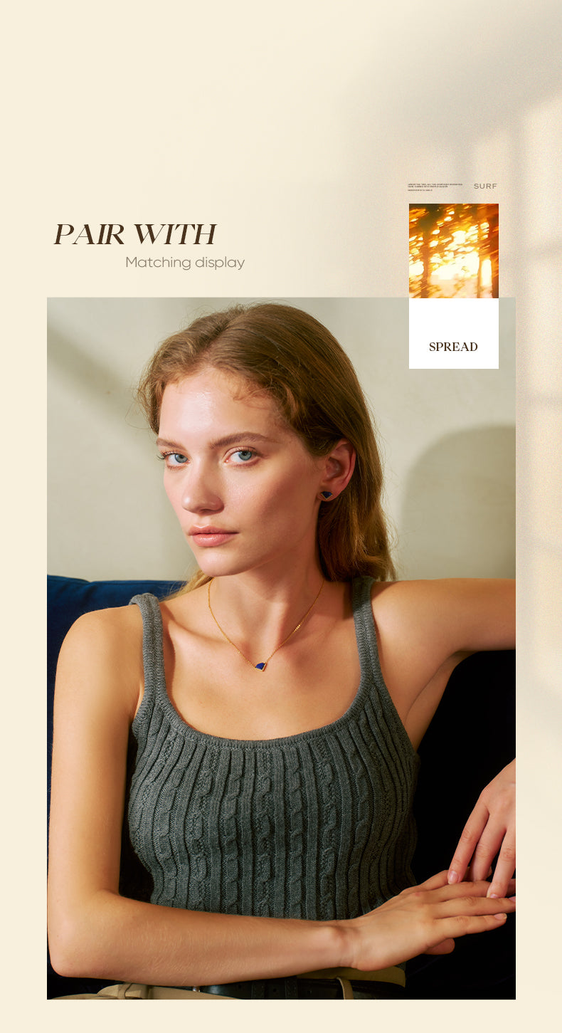 Woman wearing a gray tank top with a neutral background