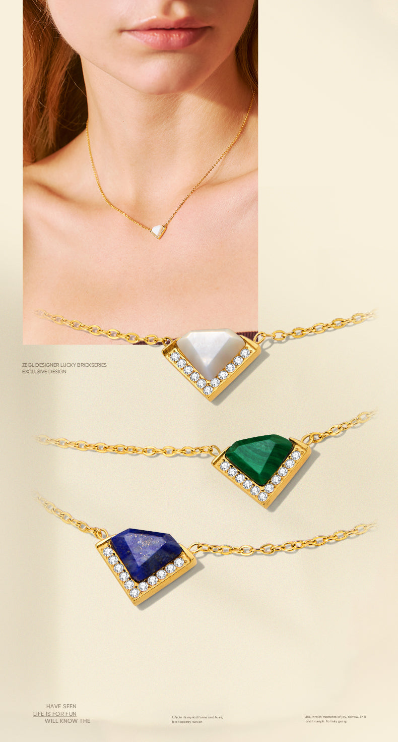 Gold necklaces with triangular gemstones on a beige background