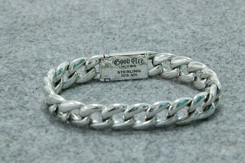 Silver bracelet with a visible brand label on a gray background