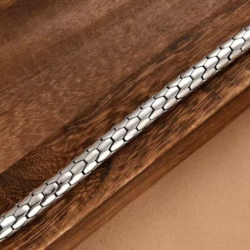Silver bracelet on a wooden surface