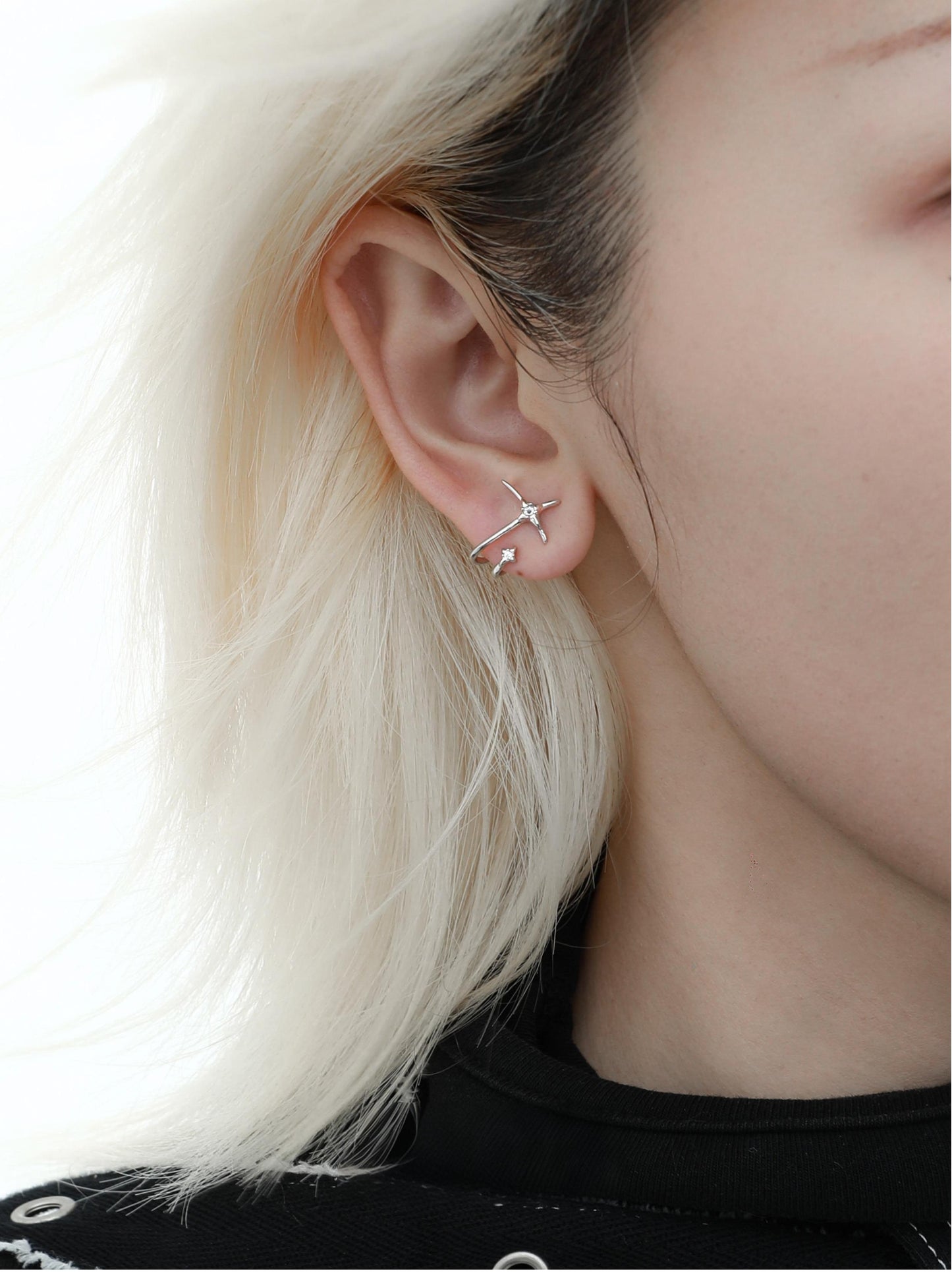 "Unisex model wearing minimalist zircon stud earrings for daily ear stack styling"