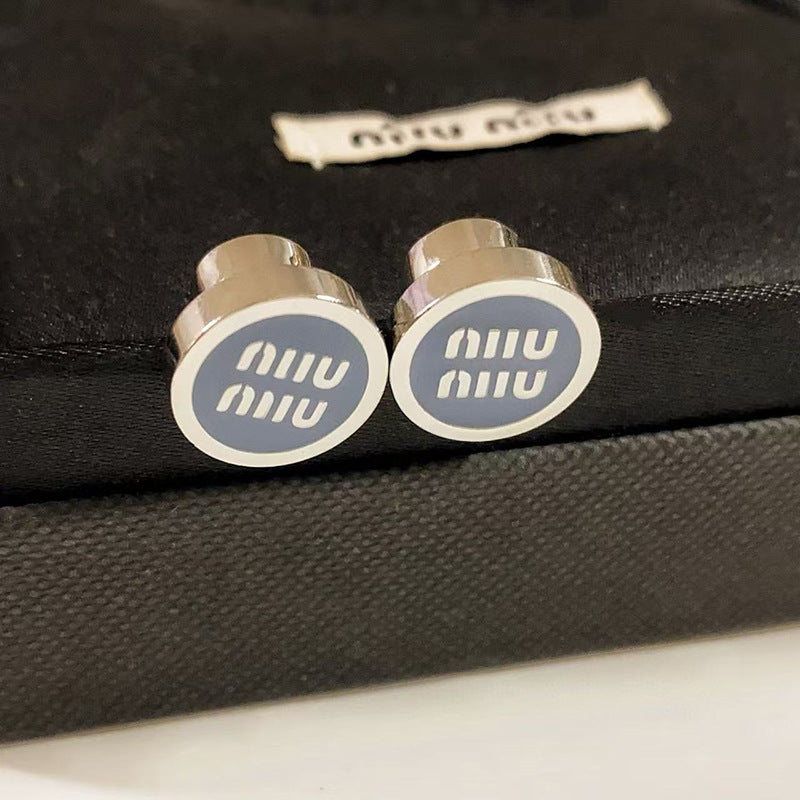 A crisp, bright shot of the earrings on a white or light grey background, highlighting the vivid enamel colors and metallic sheen. Alt text: "Miu Miu Colorful Enameled Metal Statement Earrings for Women."